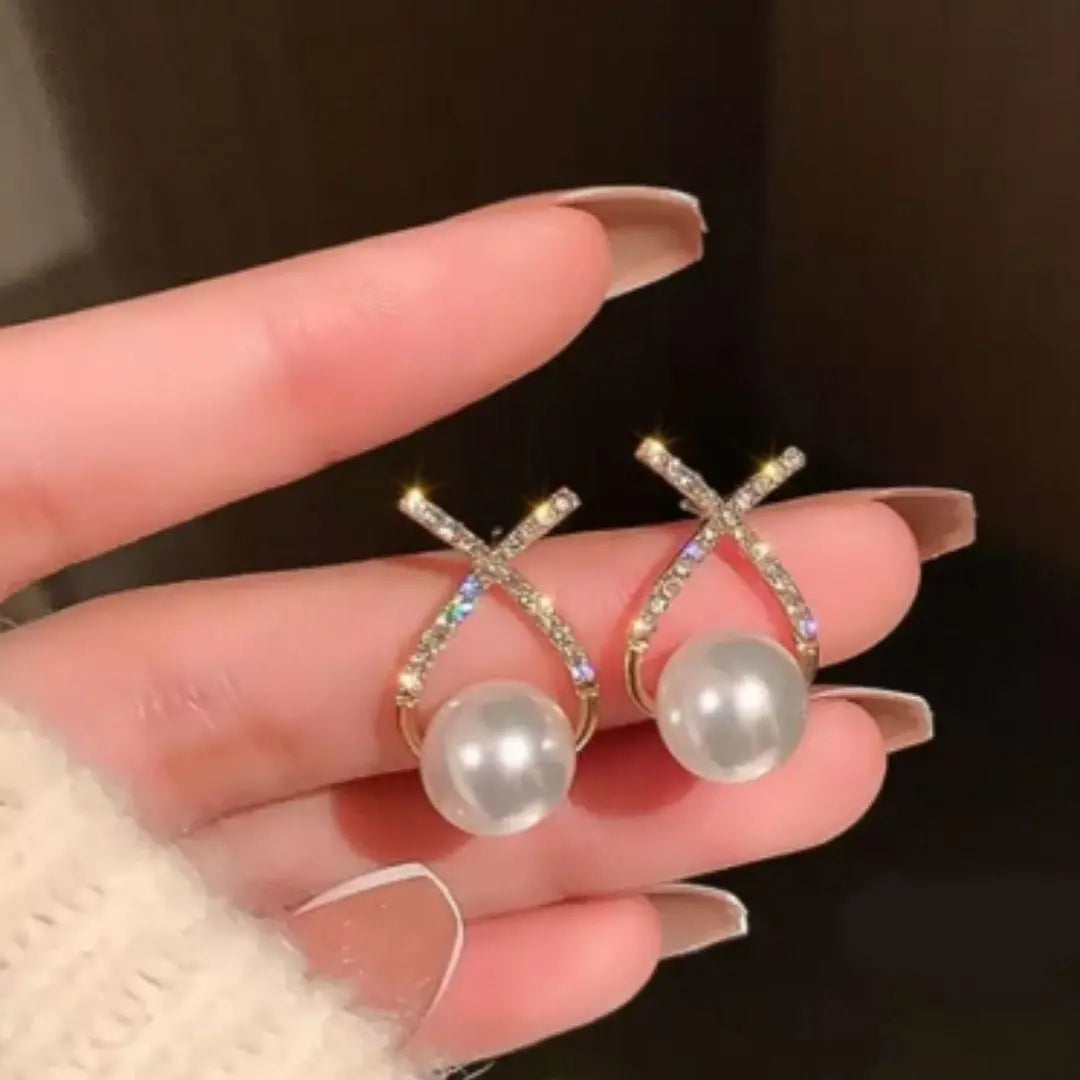 Elegant Korean studded cross pearl stud earrings in gold plating, showcasing a chic Western style for women.