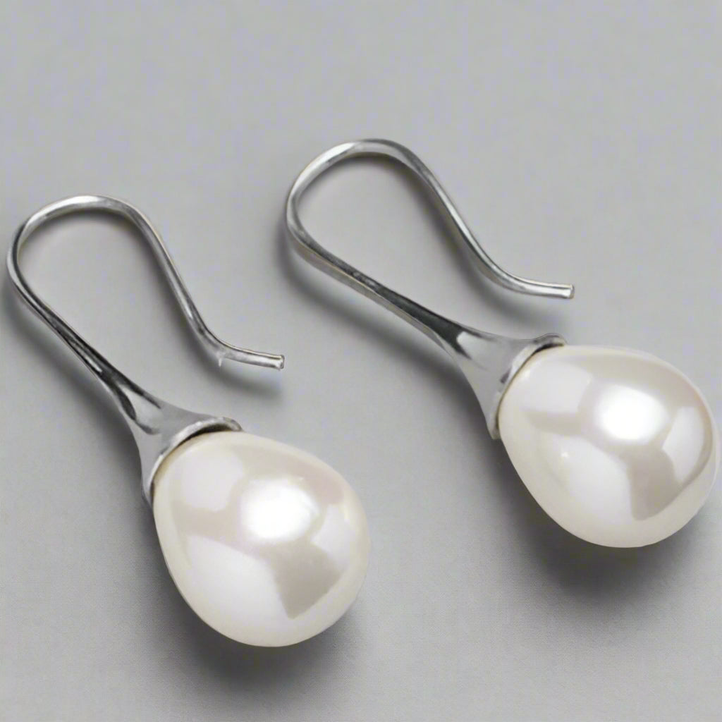 “Elegant water drop pearl earrings, with silver finish and drop silhouette”